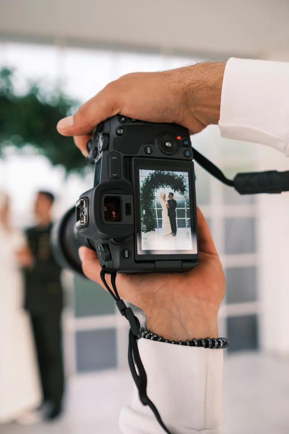 A camera screen showing a freshly taken wedding portrait