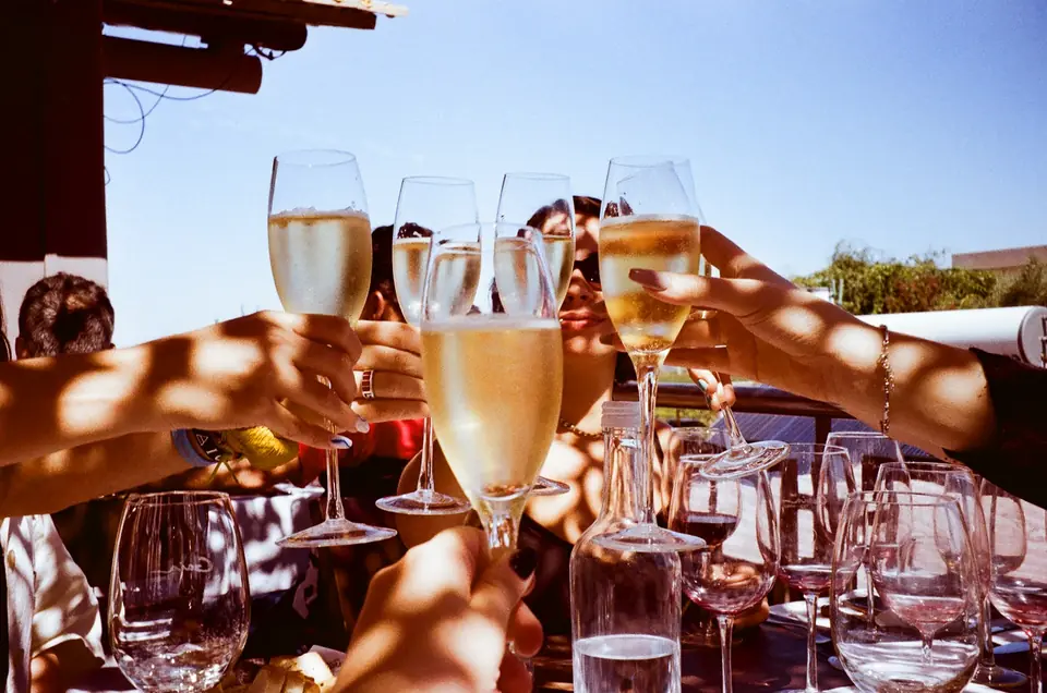 Guests raising glasses on a terrace at sunset